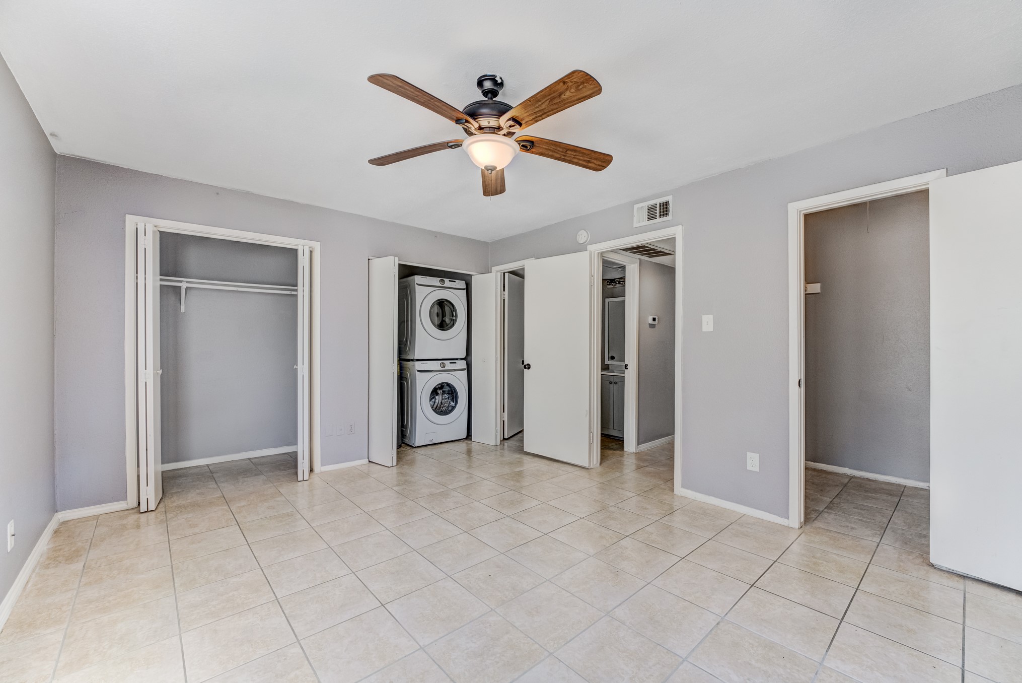 6001 Reims Road, Unit 1101 Houston, TX 77036 - Photo 27 of 35 a view of empty room with wooden floor and ceiling fan