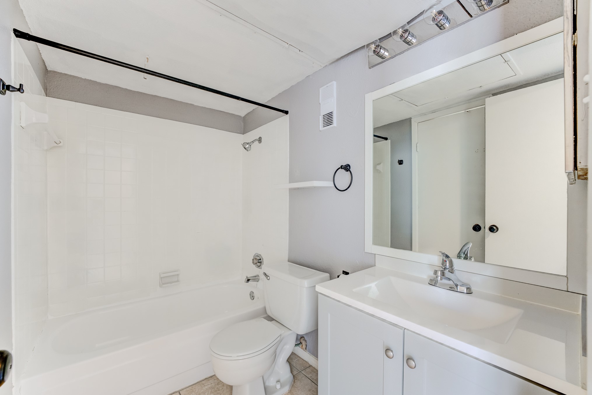 6001 Reims Road, Unit 1101 Houston, TX 77036 - Photo 28 of 35 a bathroom with a sink and mirror with toilet