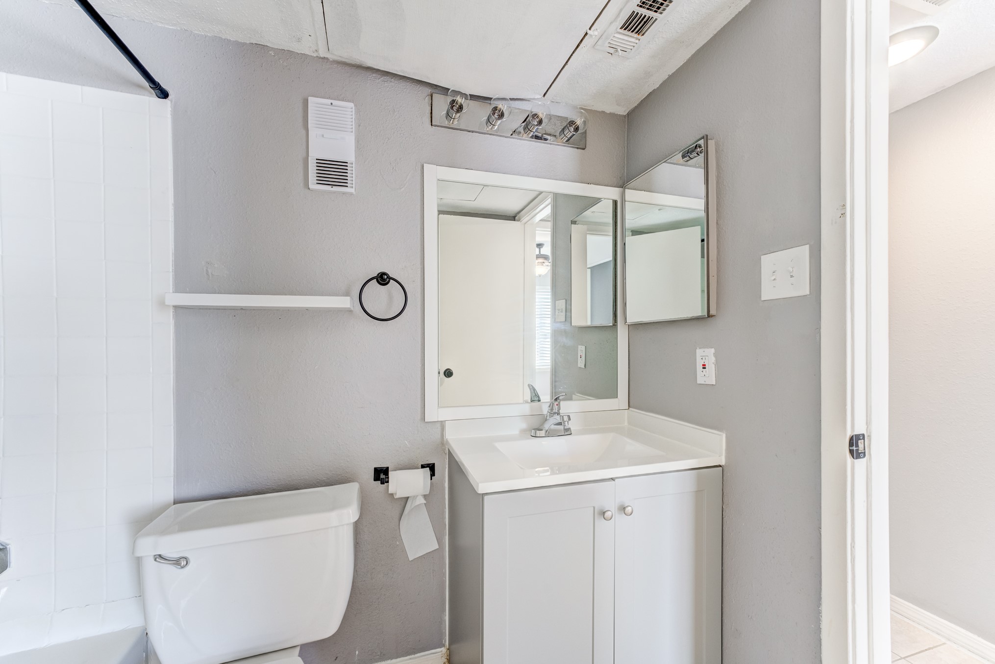 6001 Reims Road, Unit 1101 Houston, TX 77036 - Photo 29 of 35 a bathroom with a sink a toilet a mirror and shower