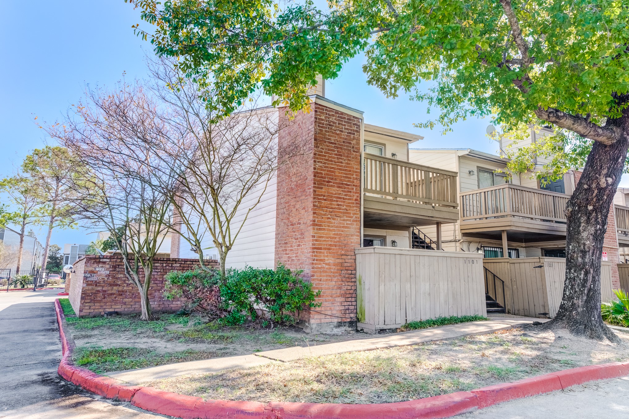 6001 Reims Road, Unit 1101 Houston, TX 77036 - Photo 3 of 35 a view of a grey house with a yard