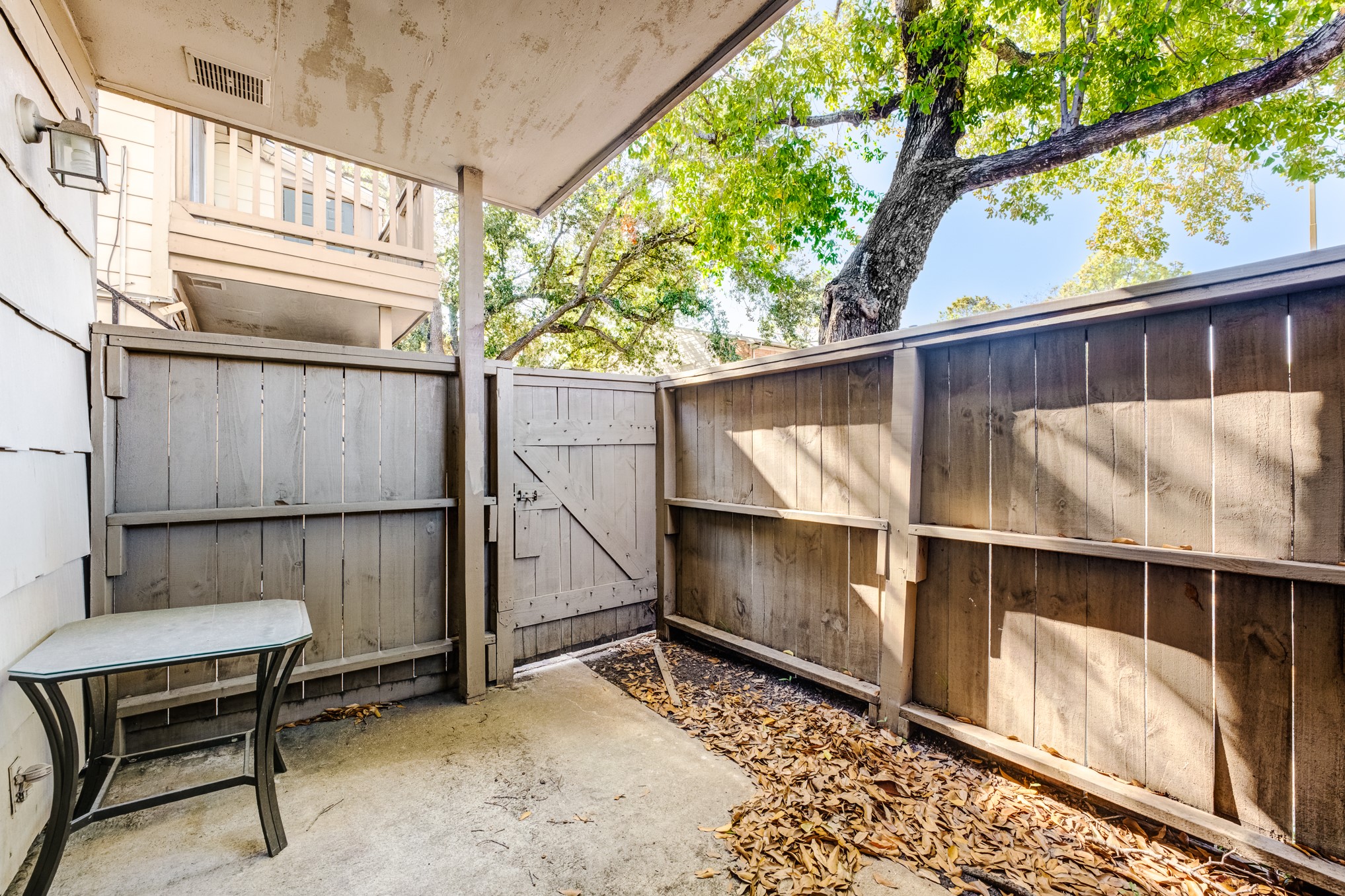 6001 Reims Road, Unit 1101 Houston, TX 77036 - Photo 32 of 35 a backyard of a house with table and chairs