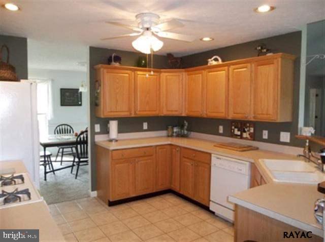 3008 Bowser Road New Freedom, PA 17349 - Photo 19 of 36 a large white kitchen with a sink and dishwasher a stove top oven with wooden floor