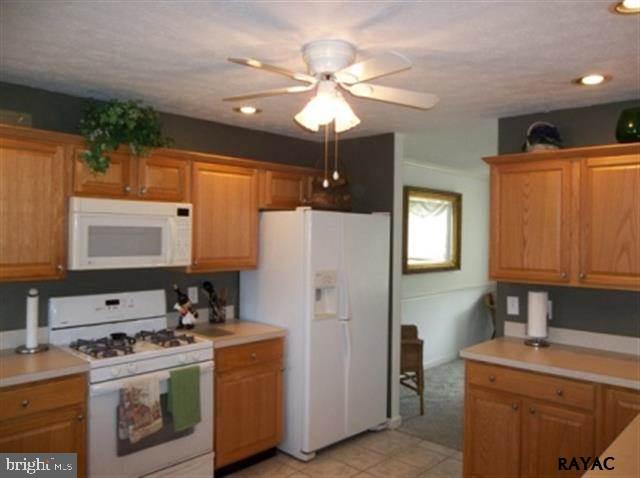 3008 Bowser Road New Freedom, PA 17349 - Photo 20 of 36 a kitchen with stainless steel appliances granite countertop a sink a stove and a refrigerator