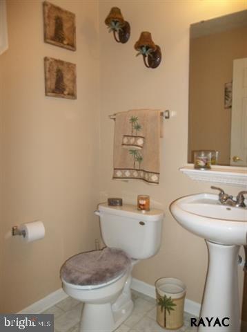 3008 Bowser Road New Freedom, PA 17349 - Photo 21 of 36 a bathroom with a toilet sink and mirror