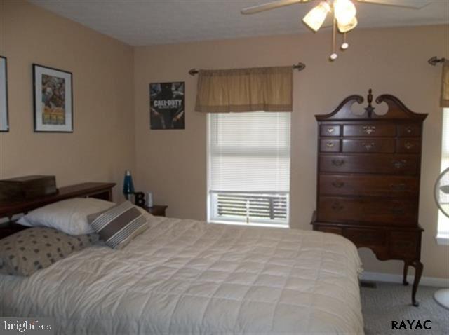 3008 Bowser Road New Freedom, PA 17349 - Photo 27 of 36 a bedroom with a bed and a chandelier