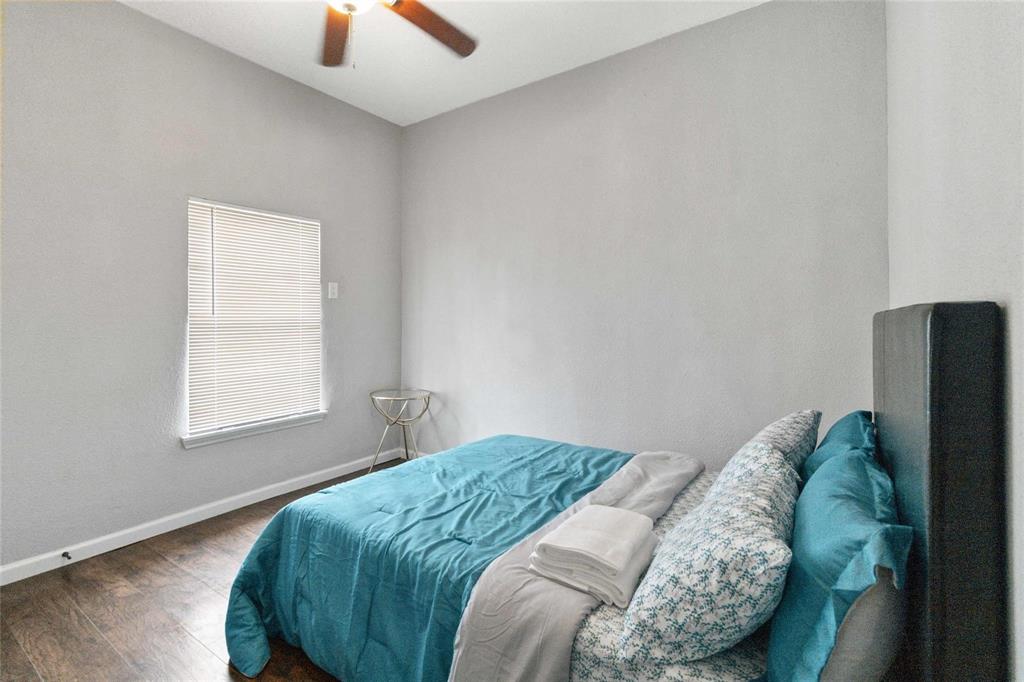 5524 Junius Street Dallas, TX 75214 - Photo 11 of 22 a bedroom with a bed and a window
