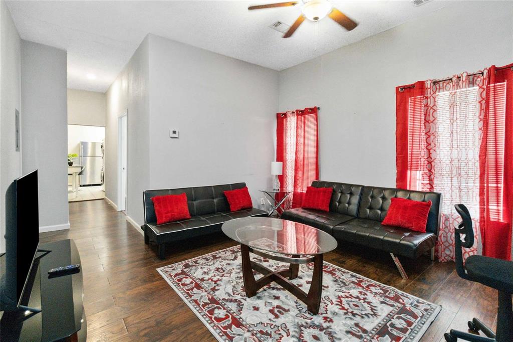 5524 Junius Street Dallas, TX 75214 - Photo 13 of 22 a living room with furniture a flat screen tv and a table