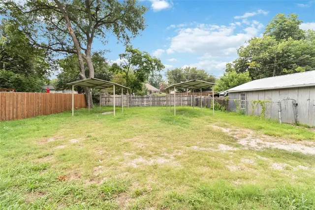 a view of a house with a yard and sitting area