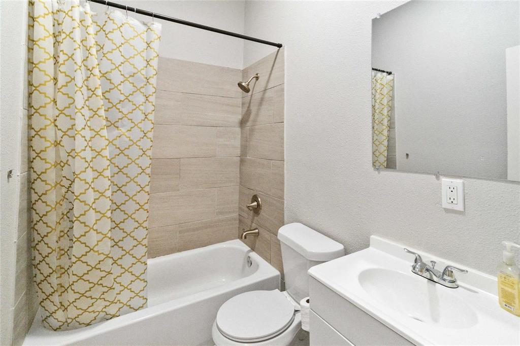 5524 Junius Street Dallas, TX 75214 - Photo 5 of 22 a bathroom with a sink toilet and shower