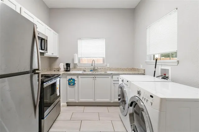 a kitchen with a sink a washer and dryer