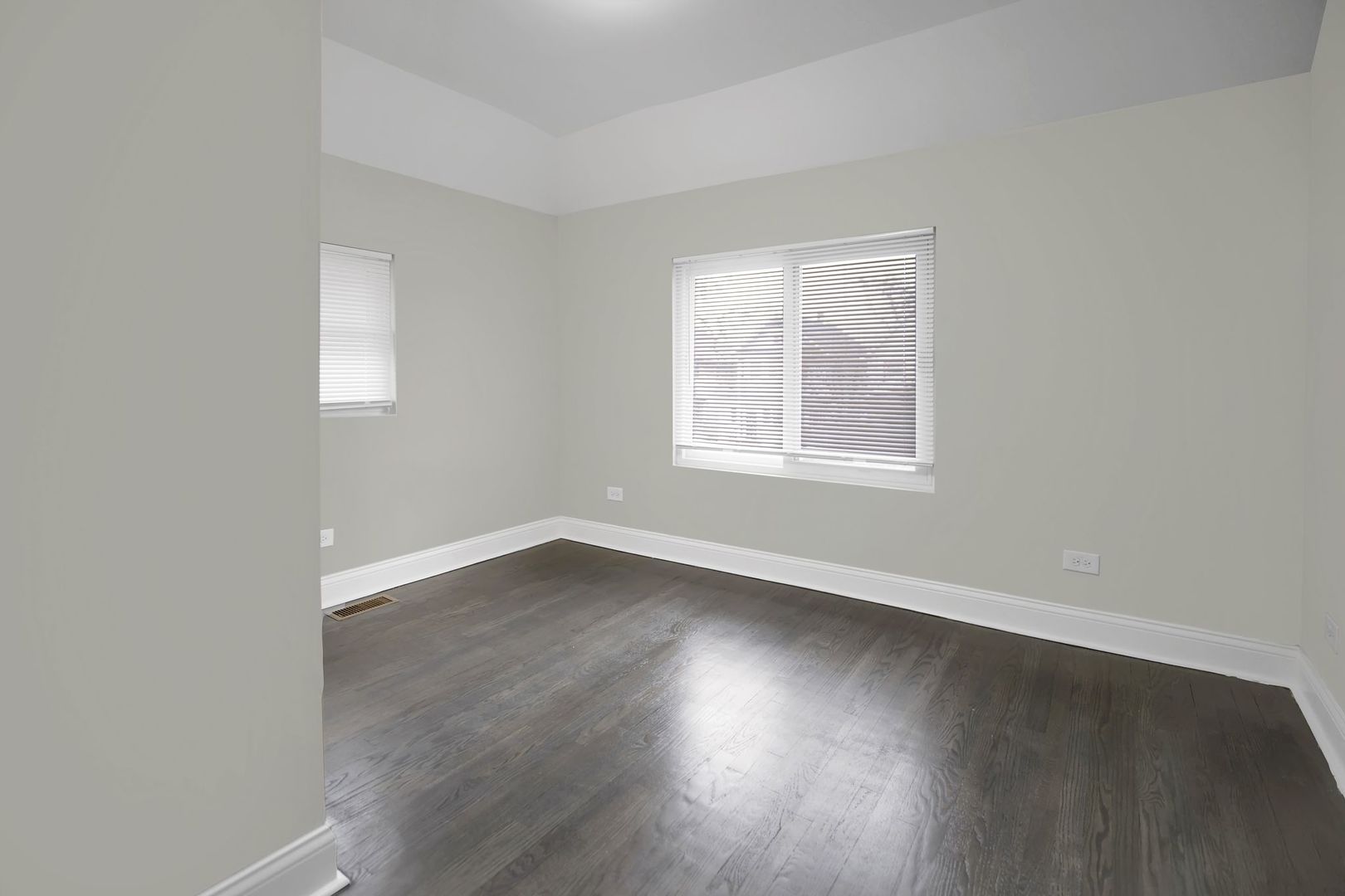 5219 West Monroe Street Chicago, IL 60644 - Photo 14 of 23 an empty room with wooden floor and windows