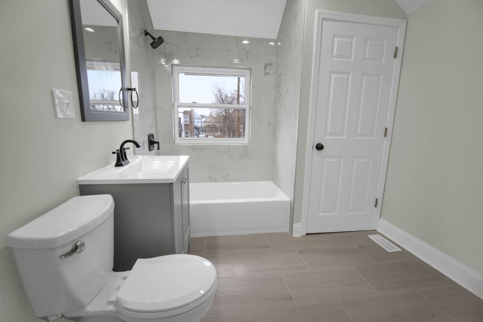 5219 West Monroe Street Chicago, IL 60644 - Photo 16 of 23 a bathroom with a sink a toilet a mirror and bathtub