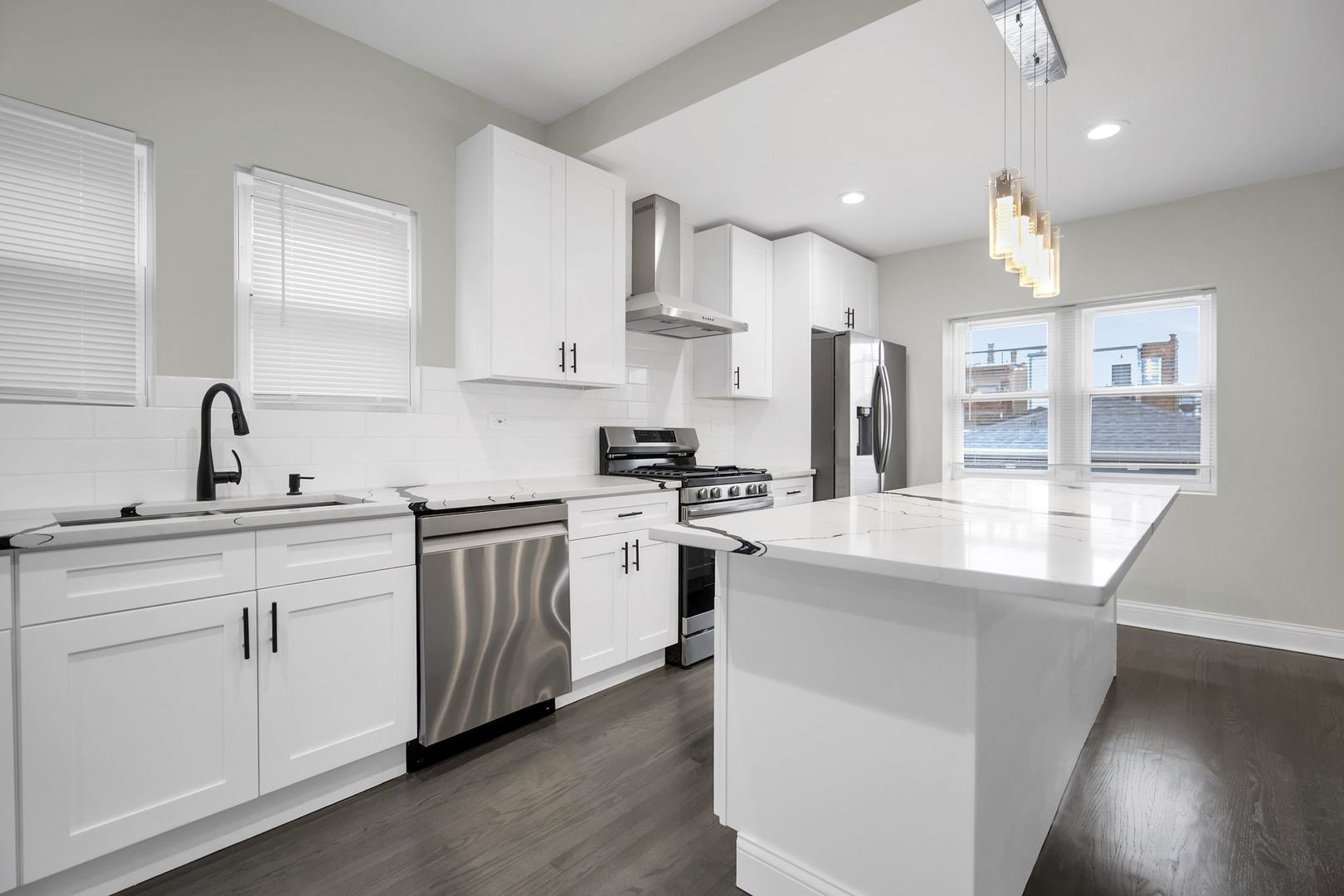 5219 West Monroe Street Chicago, IL 60644 - Photo 2 of 23 a kitchen with white cabinets and stainless steel appliances
