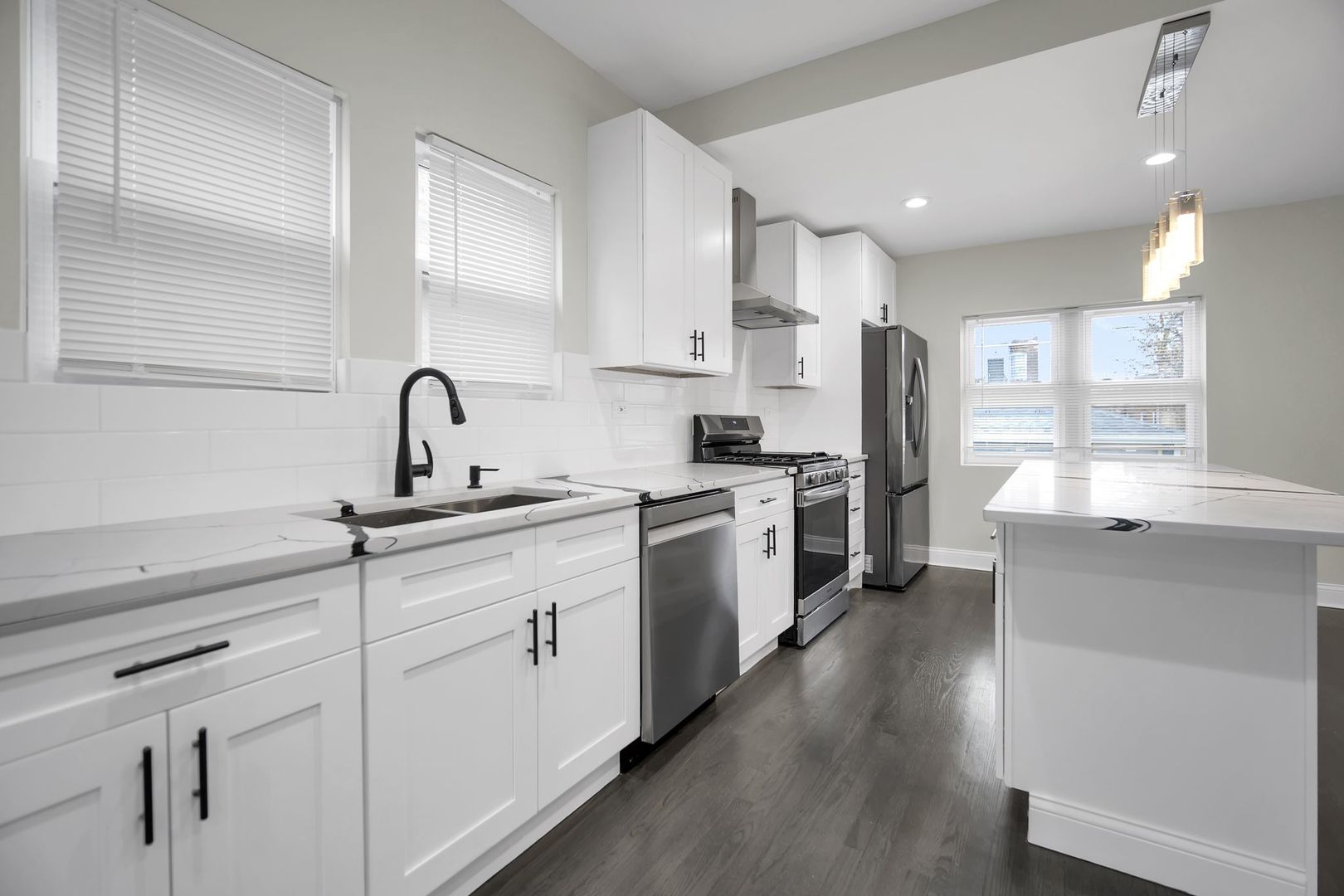 5219 West Monroe Street Chicago, IL 60644 - Photo 5 of 23 a kitchen with white cabinets and white appliances