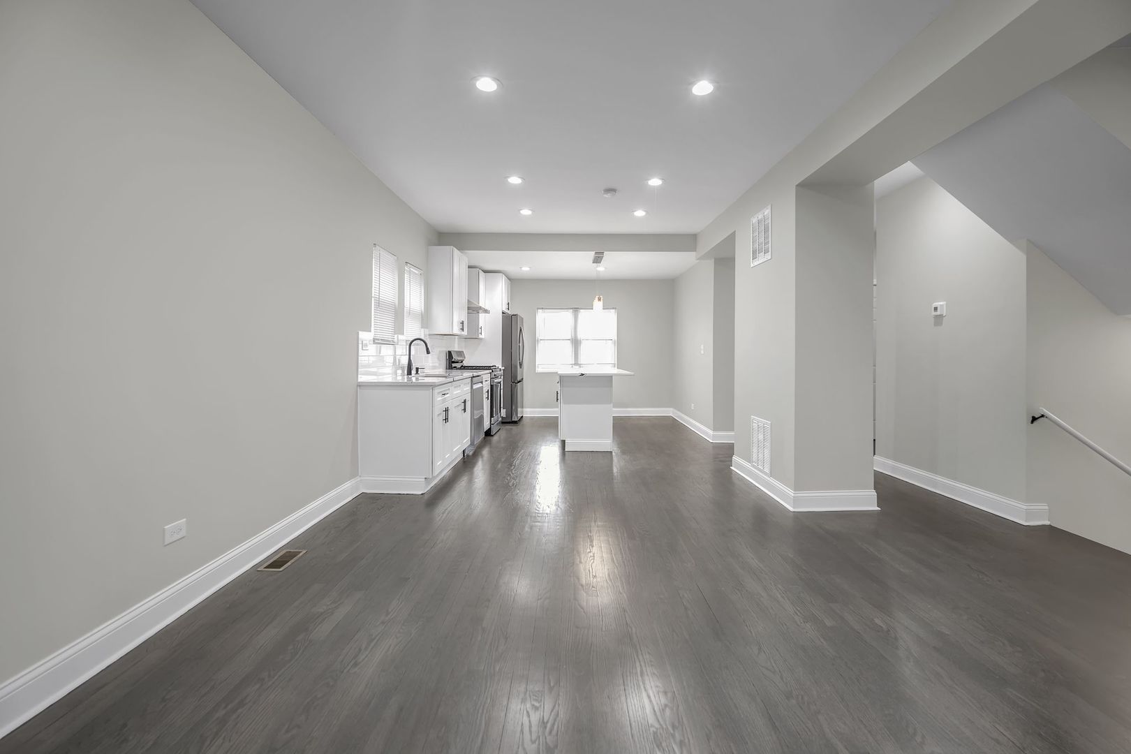 5219 West Monroe Street Chicago, IL 60644 - Photo 6 of 23 an empty room with wooden floor and windows