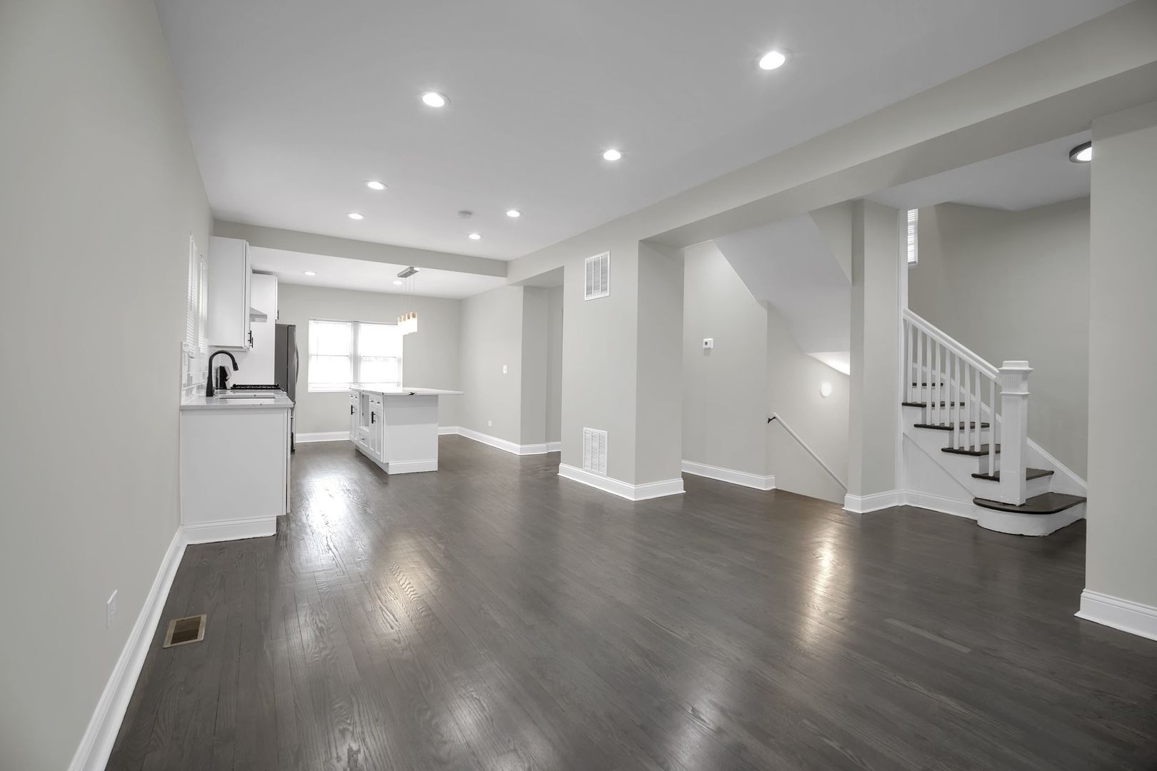 5219 West Monroe Street Chicago, IL 60644 - Photo 8 of 23 a view of an empty room with wooden floor and windows