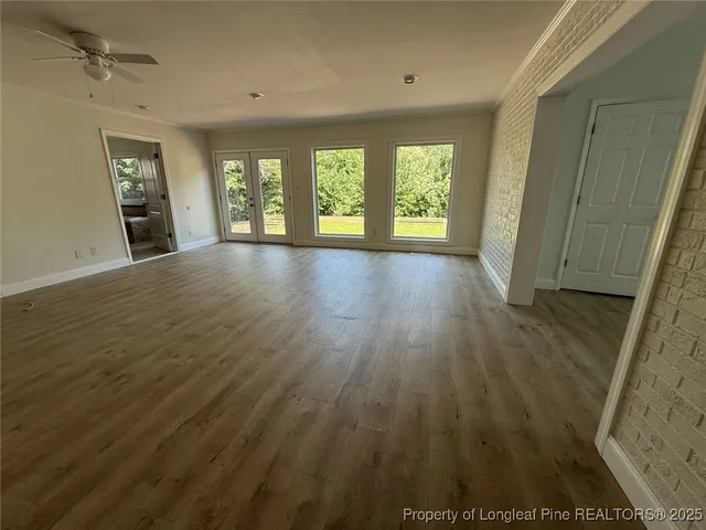 wooden floor in an empty room with a window