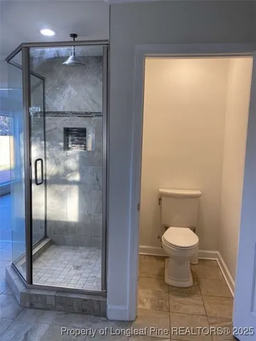 a bathroom with a toilet and a shower