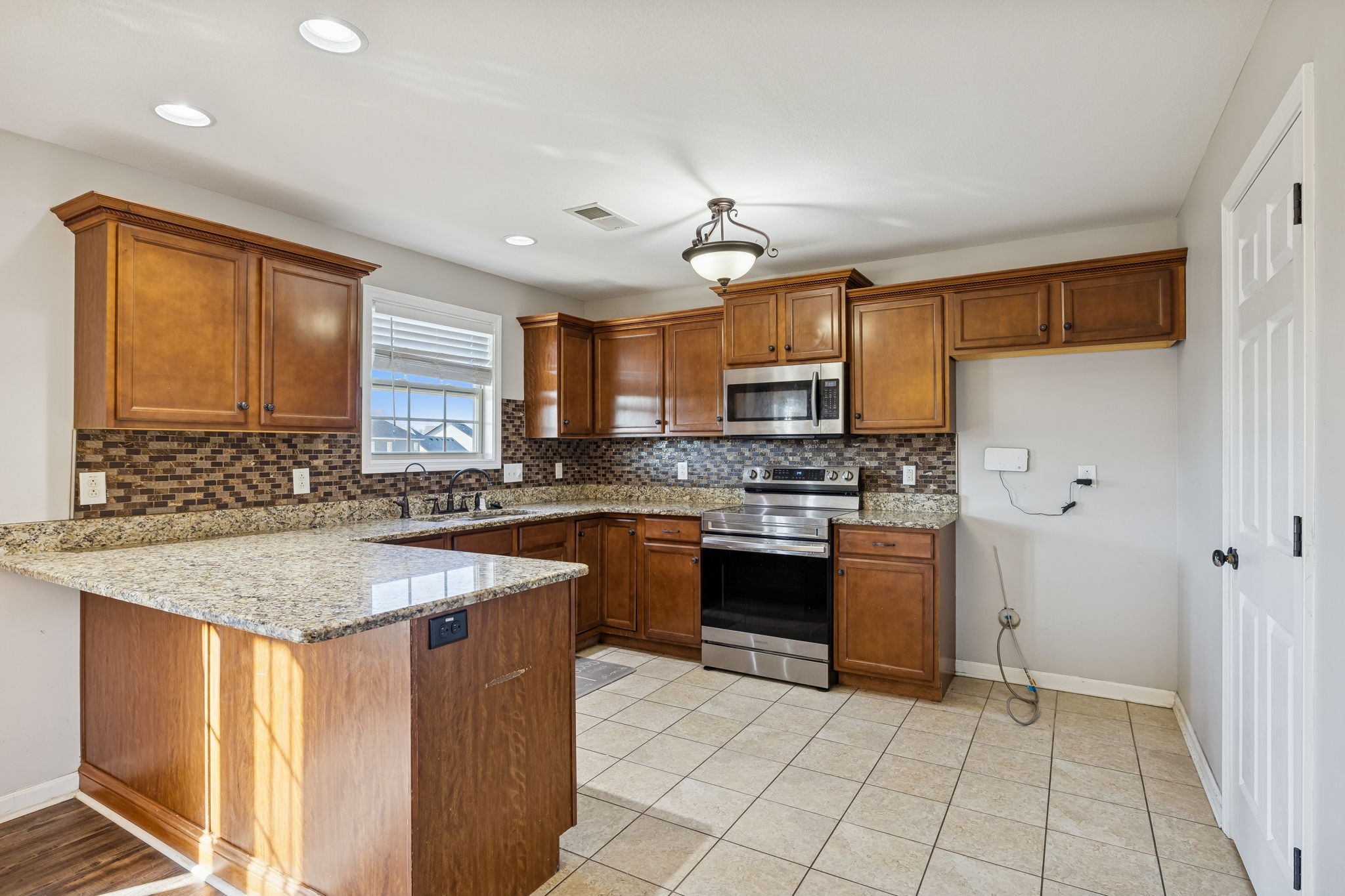 3760 Suiter Road Clarksville, TN 37040 - Photo 11 of 39 a kitchen with stainless steel appliances granite countertop a sink stove and refrigerator