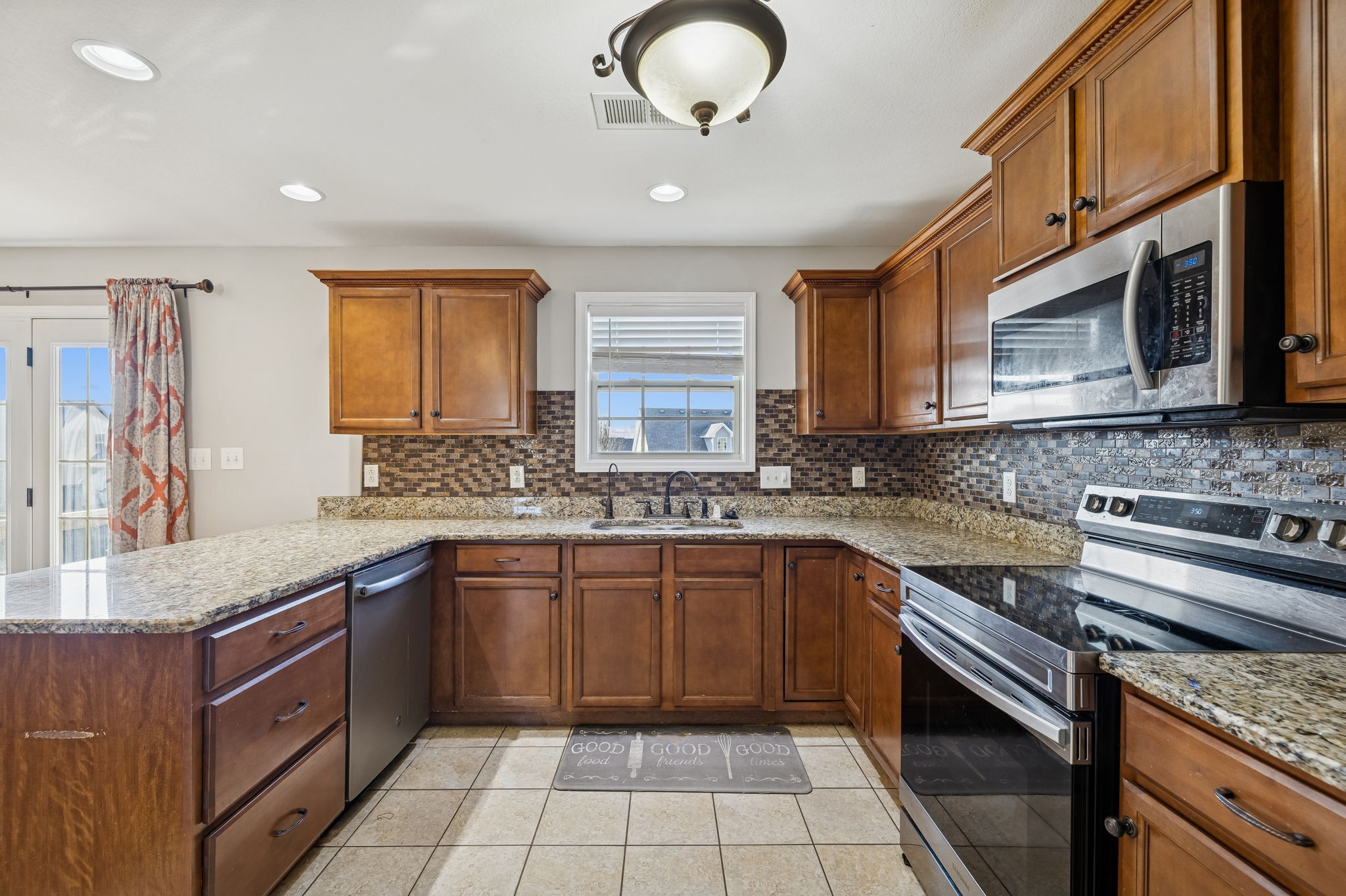 3760 Suiter Road Clarksville, TN 37040 - Photo 12 of 39 a kitchen with stainless steel appliances granite countertop stove microwave and sink