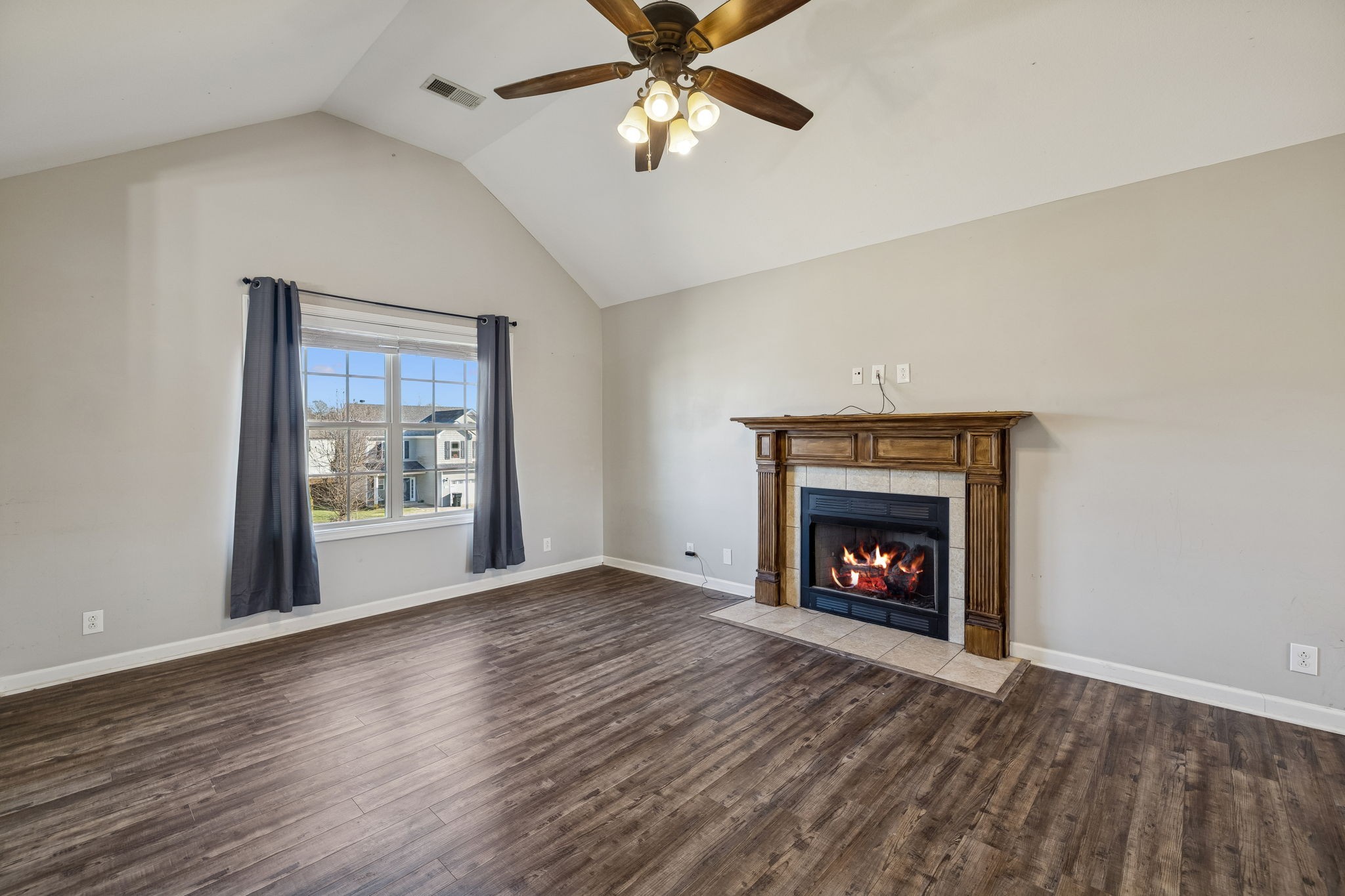 3760 Suiter Road Clarksville, TN 37040 - Photo 5 of 39 a view of an empty room with wooden floor fireplace and a window