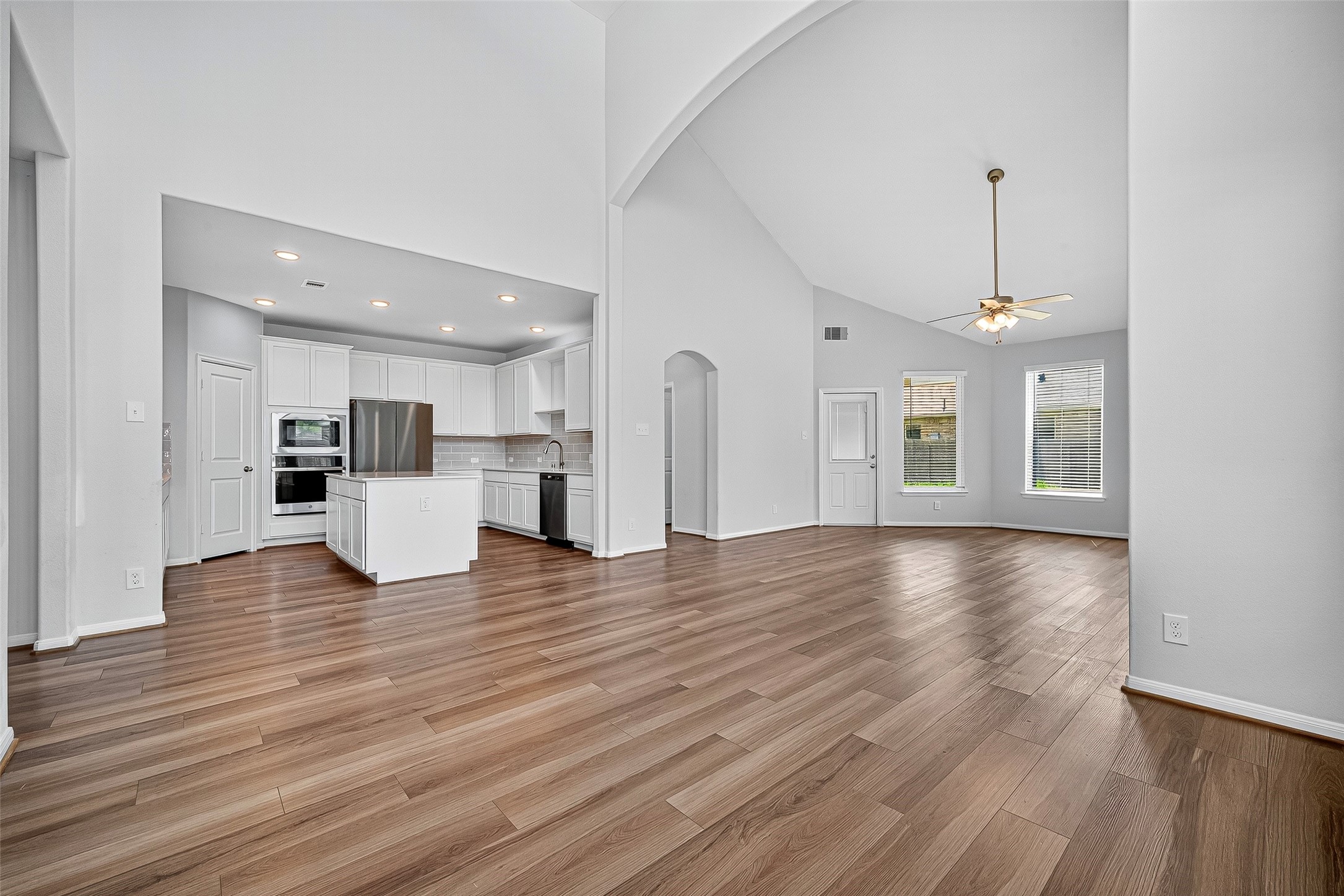 10511 Amador Peak Drive Rosharon, TX 77583 - Photo 14 of 41 Elegant kitchen featuring quartz countertops, stainless steel appliances, a spacious island, and ample natural light.