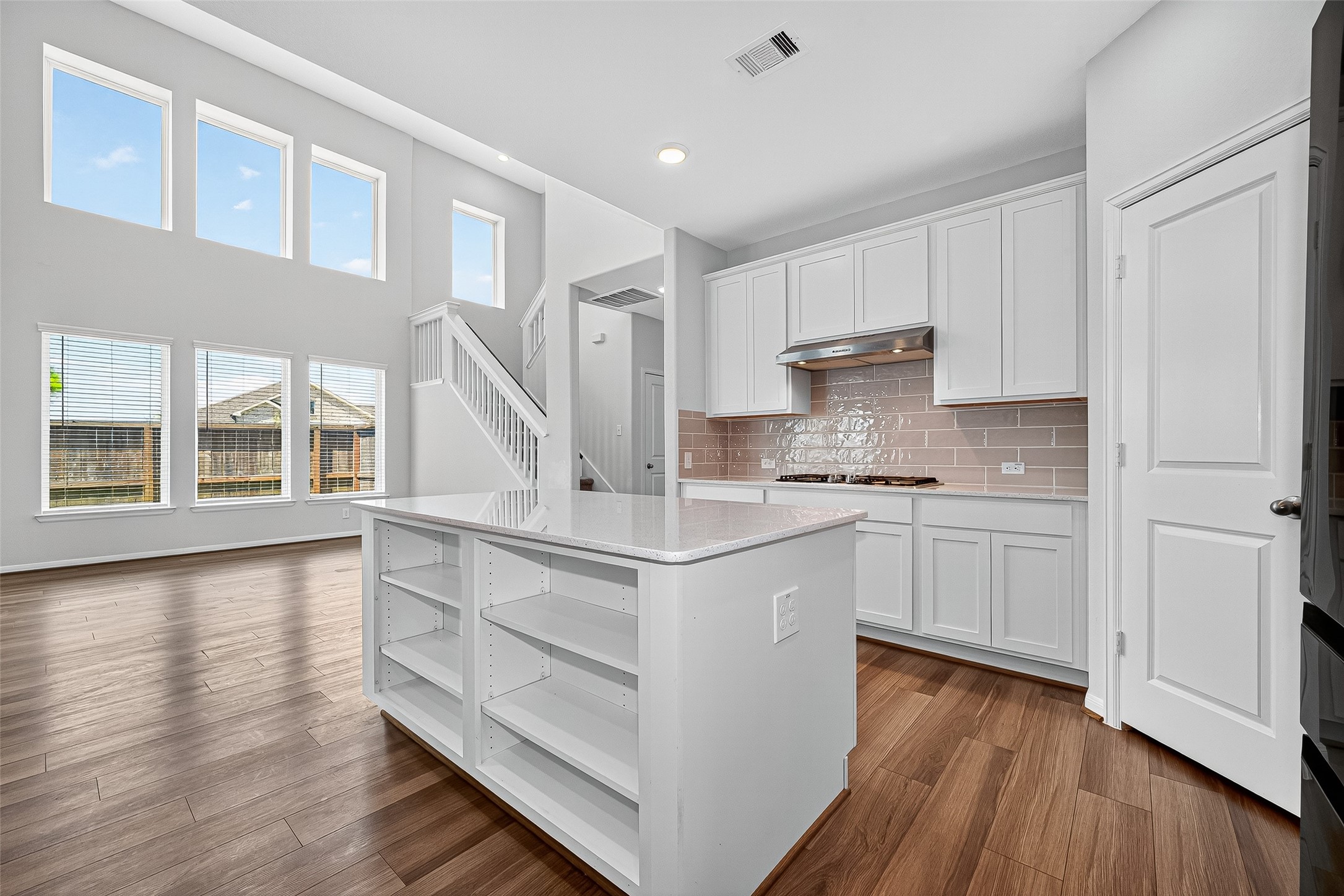 10511 Amador Peak Drive Rosharon, TX 77583 - Photo 17 of 41 a kitchen with stainless steel appliances granite countertop a stove and a white cabinets with wooden floor
