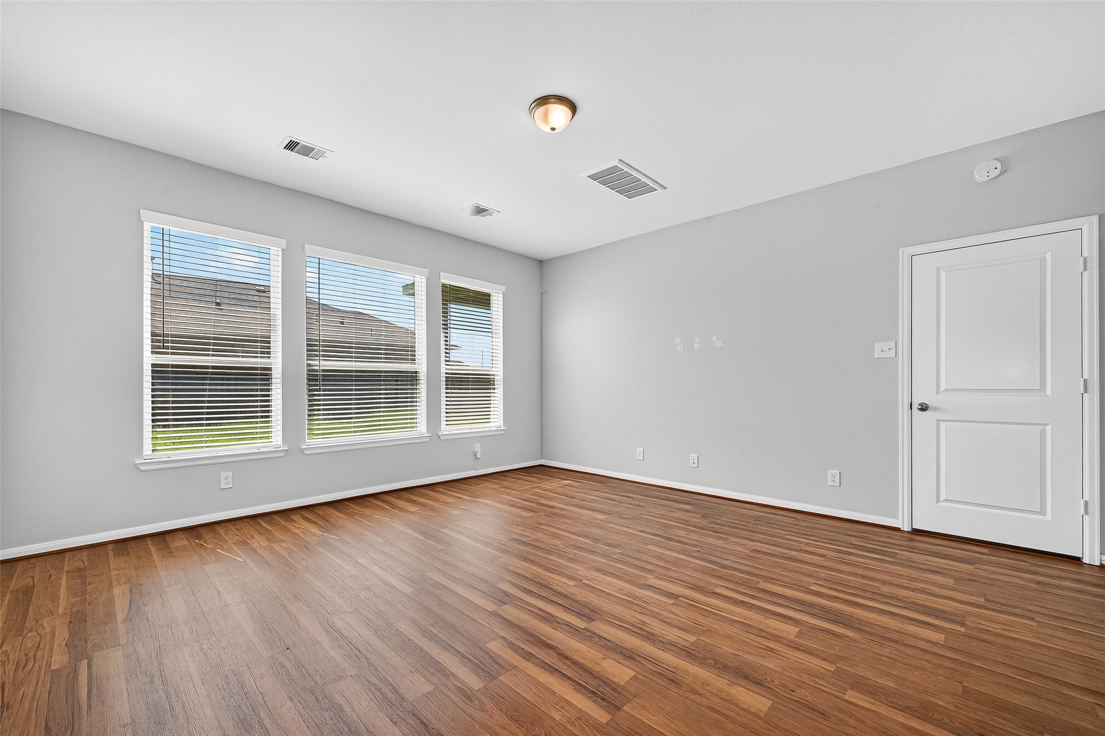 10511 Amador Peak Drive Rosharon, TX 77583 - Photo 24 of 41 a view of an empty room with wooden floor and a window
