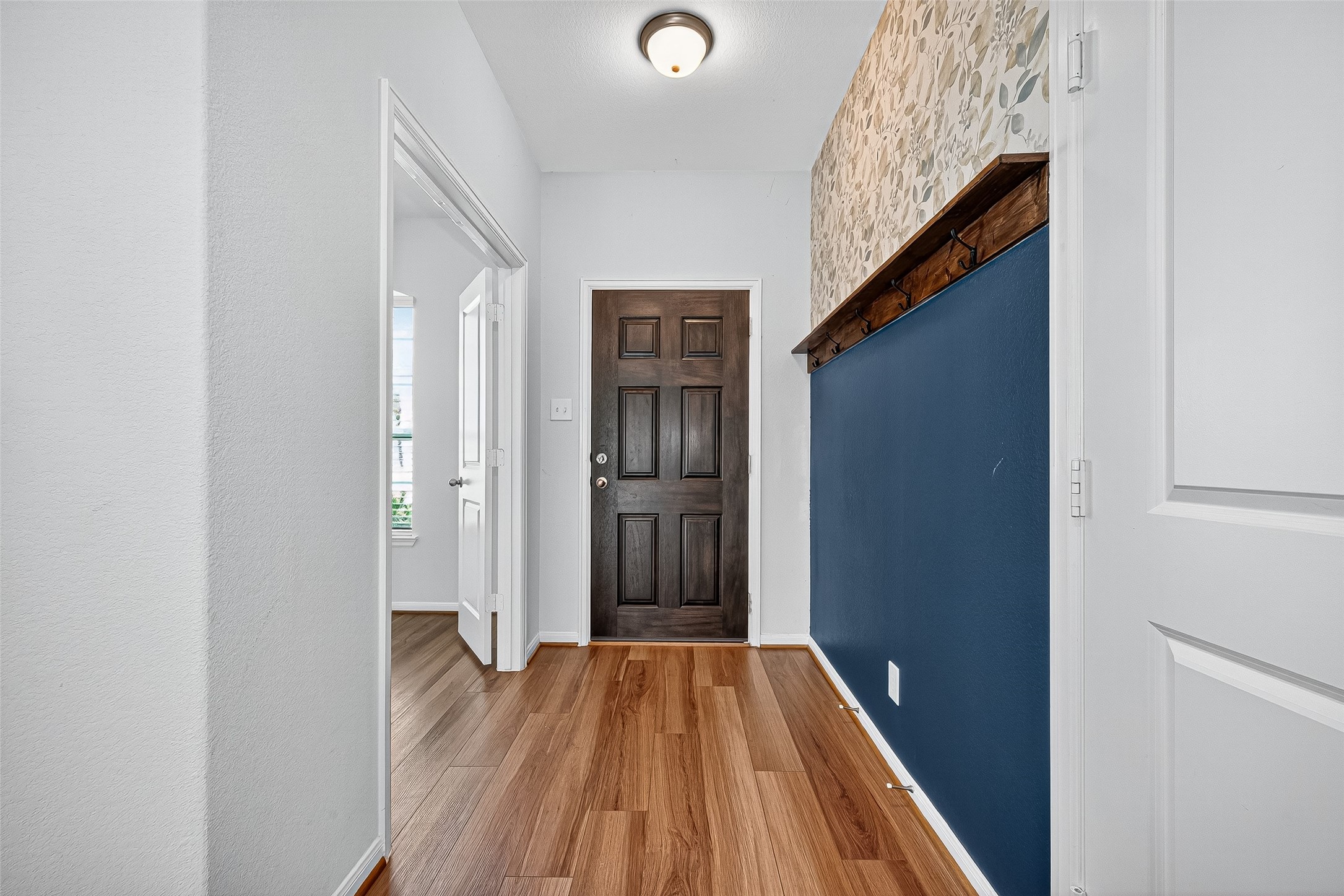 10511 Amador Peak Drive Rosharon, TX 77583 - Photo 9 of 41 a view of a hallway with wooden floor and staircase