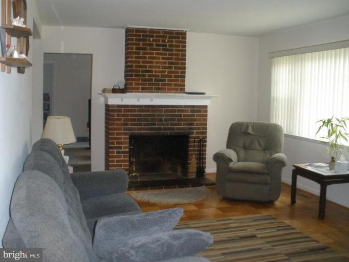 6609 Custer Street Springfield, VA 22150 - Photo 6 of 9 a living room with furniture and a fireplace
