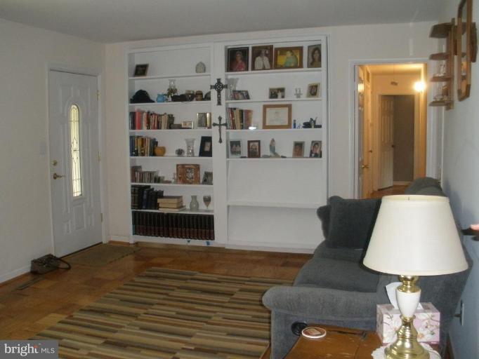 6609 Custer Street Springfield, VA 22150 - Photo 7 of 9 a living room with furniture and a lamp