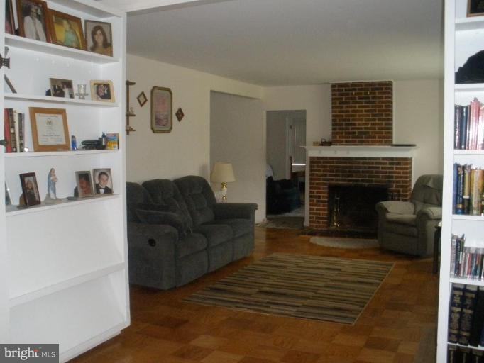 6609 Custer Street Springfield, VA 22150 - Photo 8 of 9 a living room with furniture and a fireplace