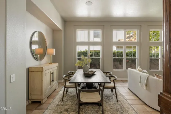 a dining room with furniture and wooden floor