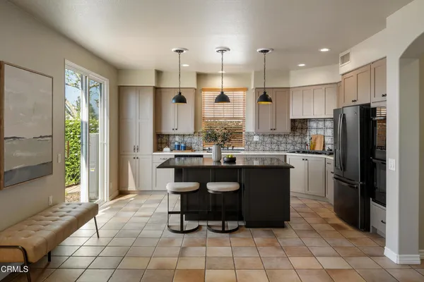 a kitchen with sink and view of living room