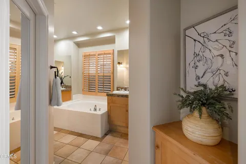 a bedroom with a bed and a mirror