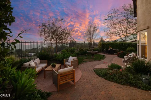 a view of house with outdoor space and sitting area