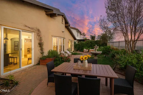 a view of a house with a yard and a garden
