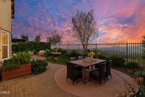 a view of roof deck with dining table and chairs