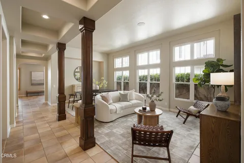 a living room with furniture and a floor to ceiling window