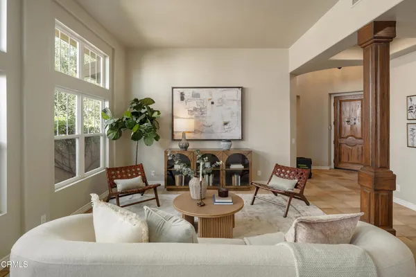 a living room with furniture and a large window