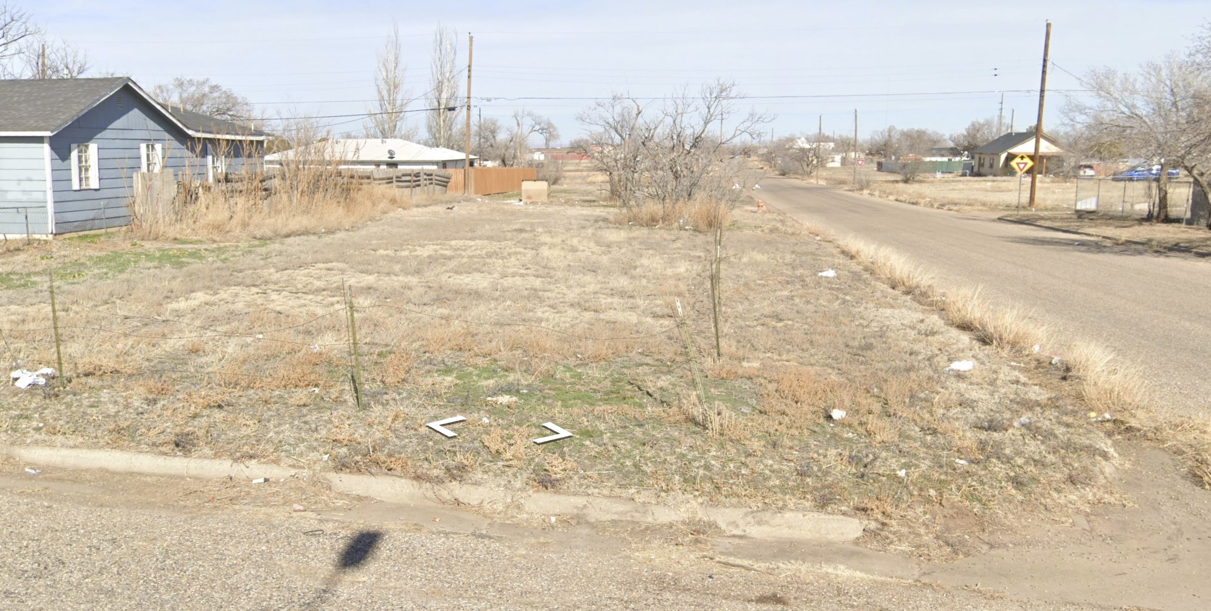 a view of residential houses with wooden fence