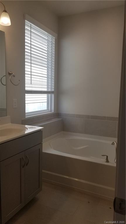 6540 Georgia Oak Road, Unit 84 Charlotte, NC 28269 - Photo 4 of 8 a bathroom with a bathtub and a shower