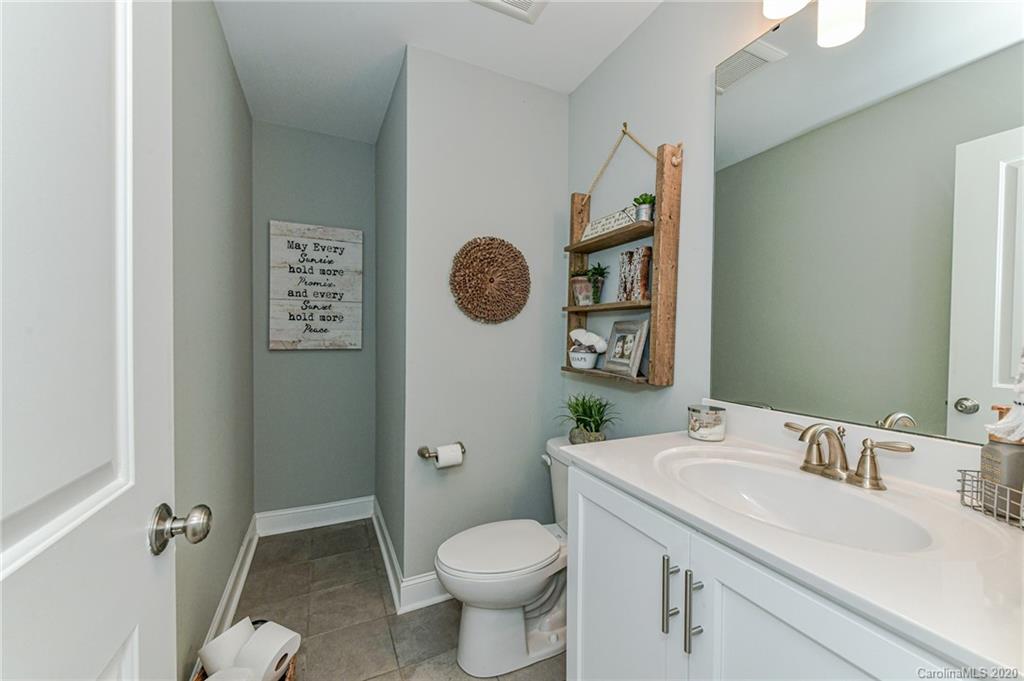 3113 East Brief Road Monroe, NC 28110 - Photo 22 of 42 a bathroom with a toilet sink and mirror