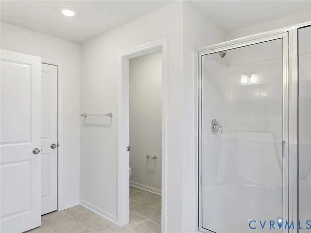 a bathroom with a glass shower door