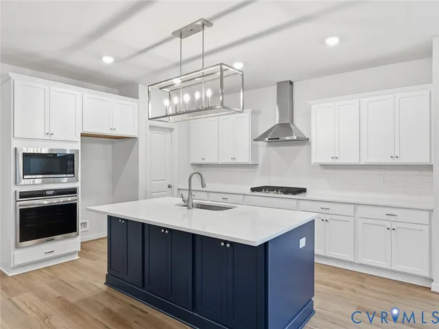 a kitchen with a sink stove and microwave