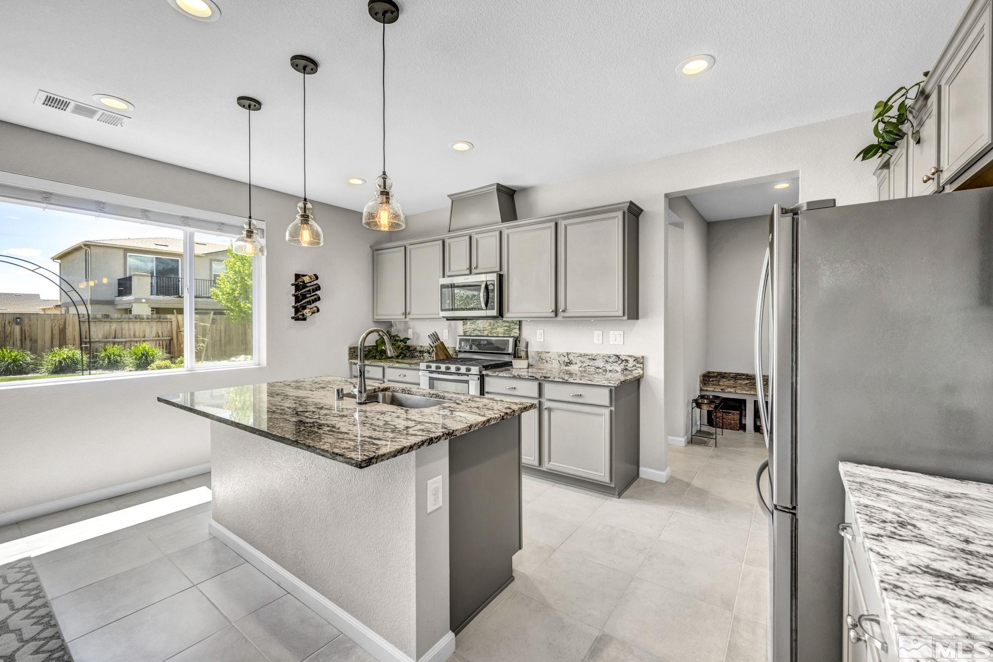 2265 Selway Drive Sparks, NV 89436 - Photo 11 of 39 a kitchen with a sink counter top space and stainless steel appliances