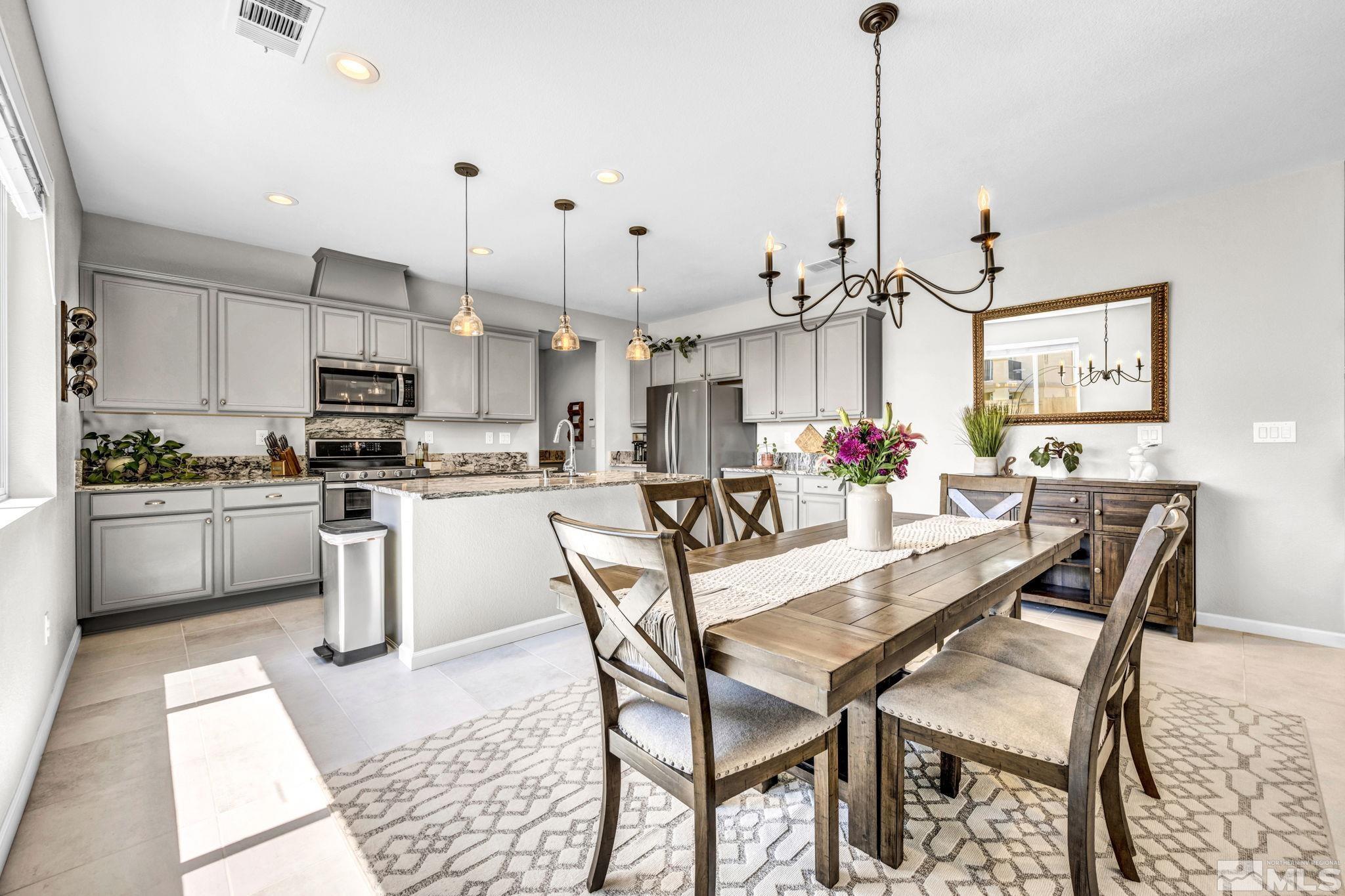 2265 Selway Drive Sparks, NV 89436 - Photo 15 of 39 a kitchen with stainless steel appliances kitchen island granite countertop a stove a sink and a refrigerator