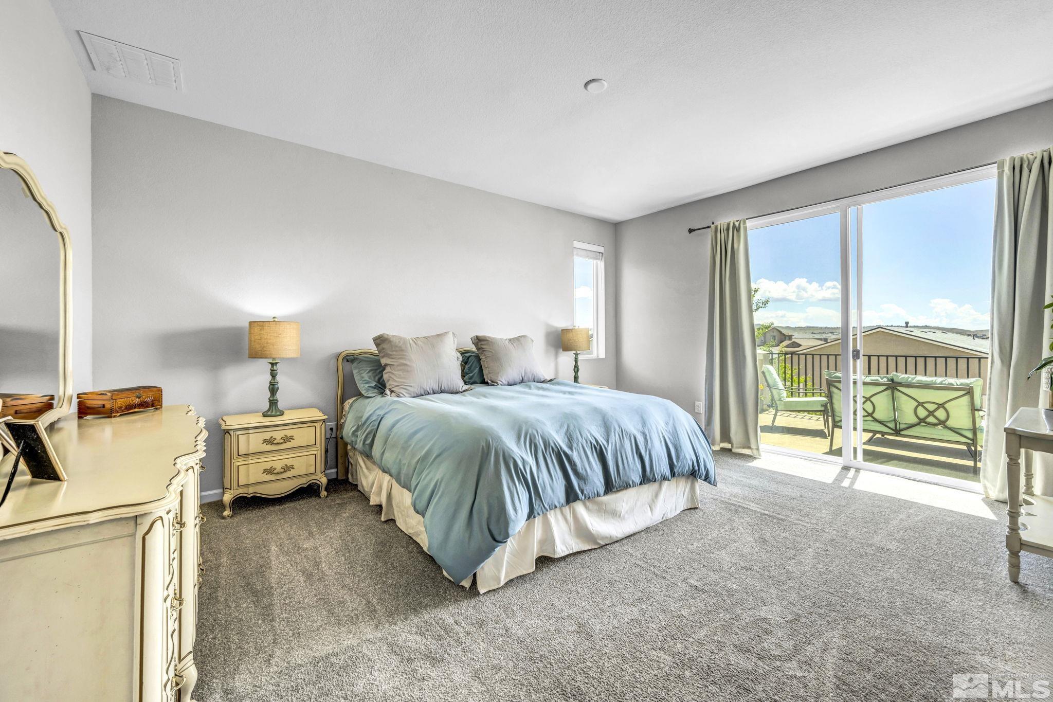 2265 Selway Drive Sparks, NV 89436 - Photo 16 of 39 a spacious bedroom with a bed and a night stand