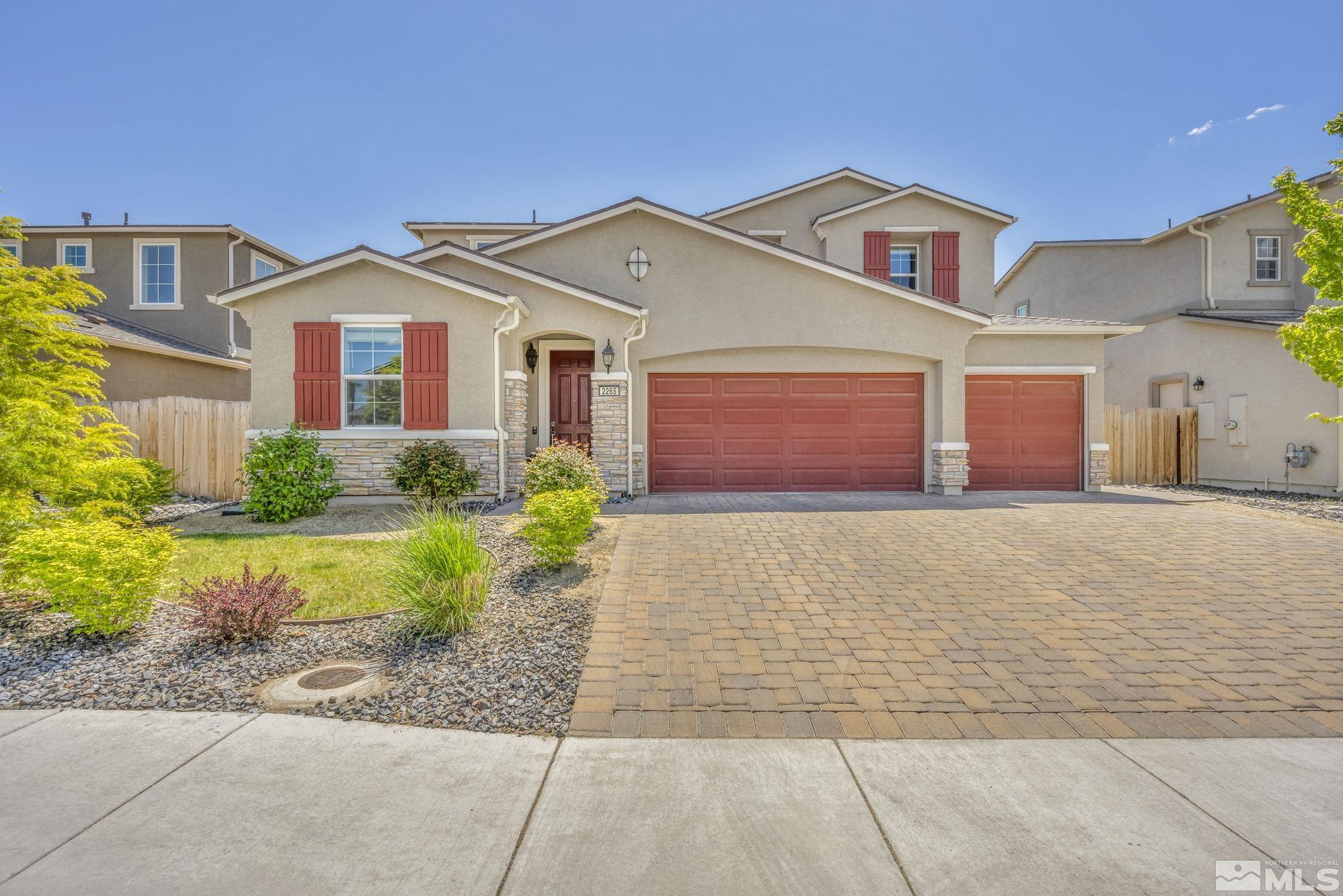 2265 Selway Drive Sparks, NV 89436 - Photo 2 of 39 a front view of a house with a yard and garage