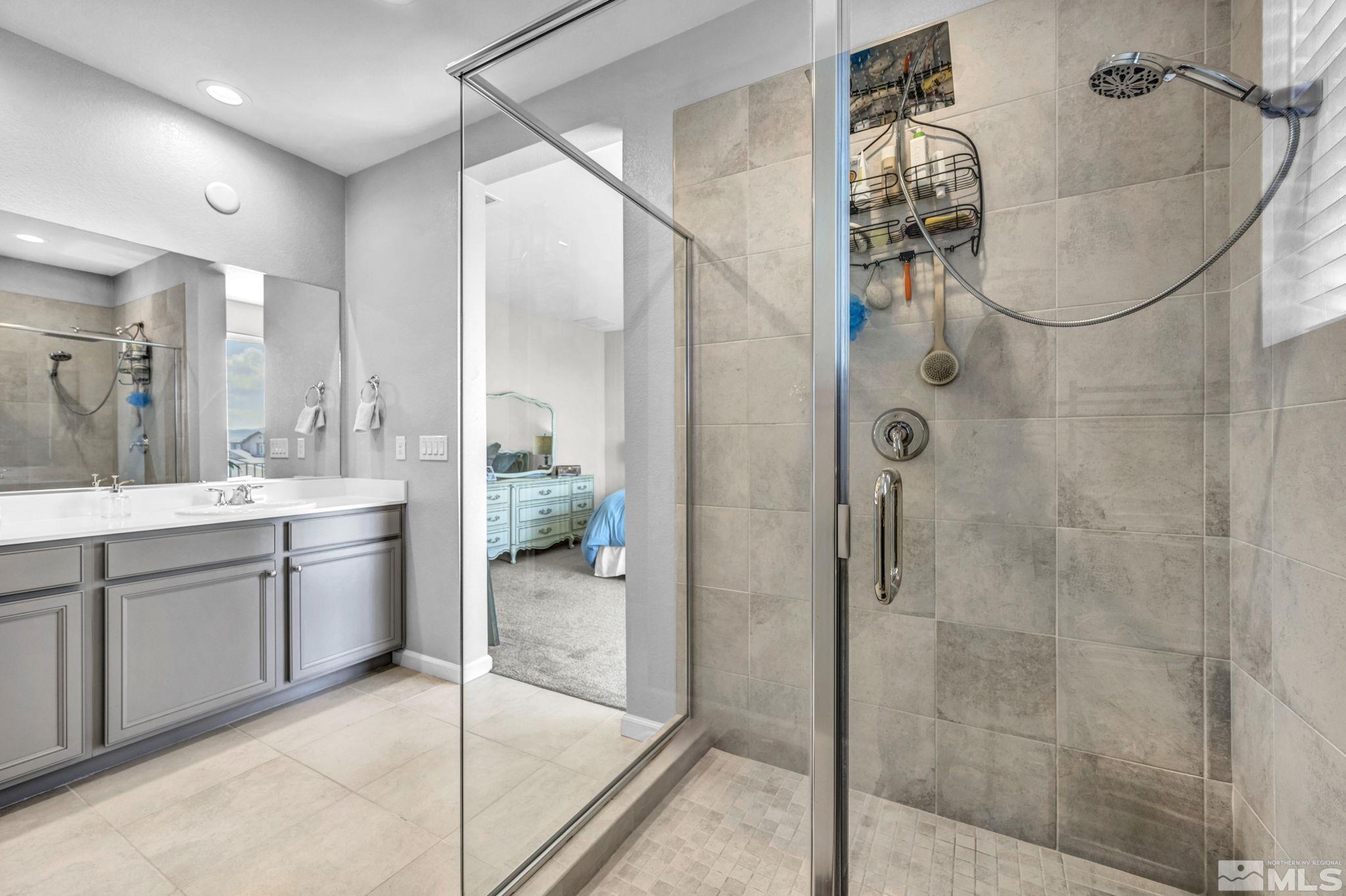 2265 Selway Drive Sparks, NV 89436 - Photo 22 of 39 a bathroom with a granite countertop shower a sink and mirror